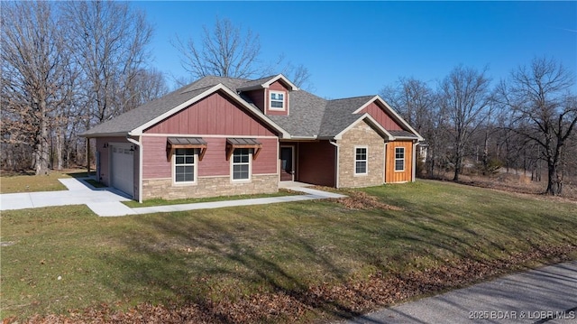 view of front of property featuring a garage and a front lawn