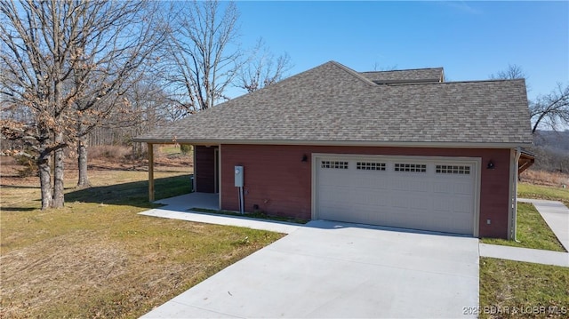 view of side of home featuring a yard and a garage