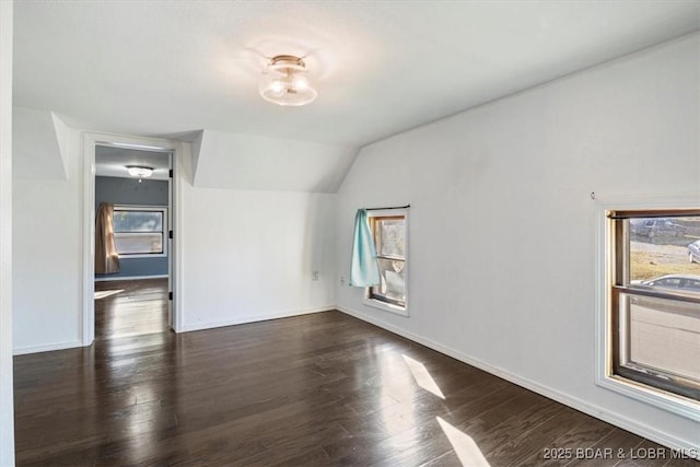 empty room featuring dark hardwood / wood-style flooring and vaulted ceiling