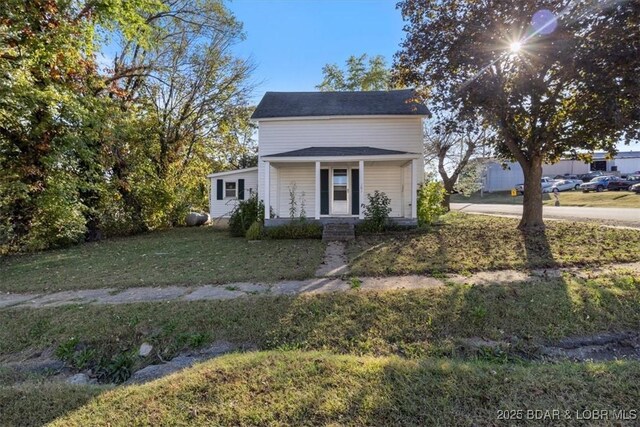 view of front of property with a porch and a front lawn