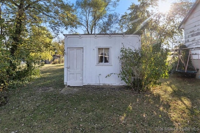 view of outbuilding featuring a lawn