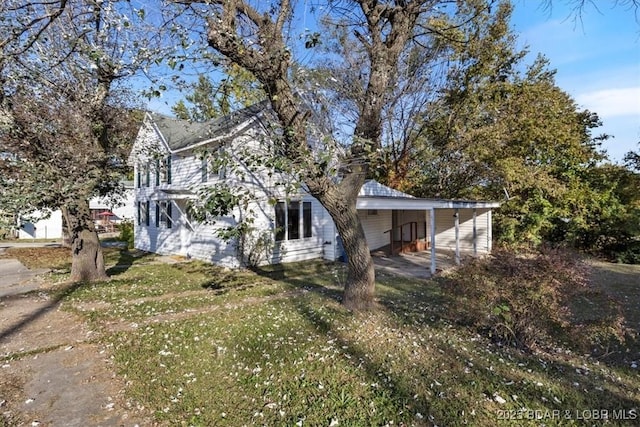 view of front of house with a front yard and a carport