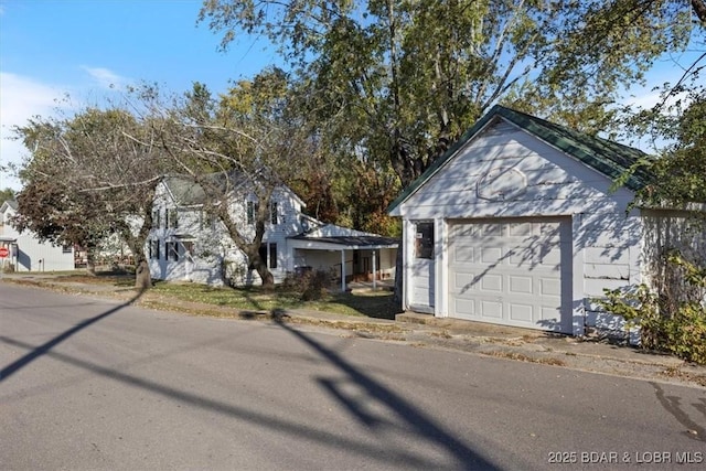 view of front facade featuring a garage and an outdoor structure