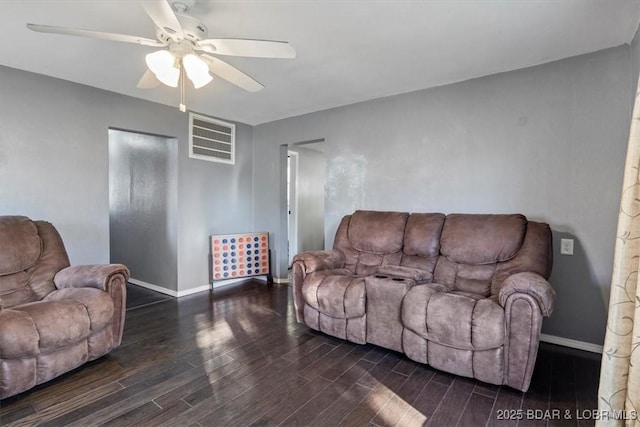 living room featuring dark hardwood / wood-style flooring and ceiling fan