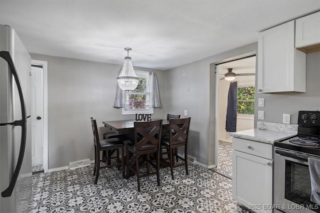 dining area with an inviting chandelier