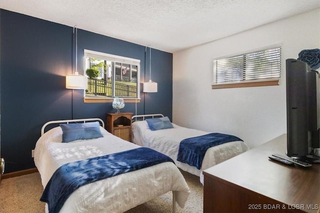 bedroom with a textured ceiling and carpet flooring