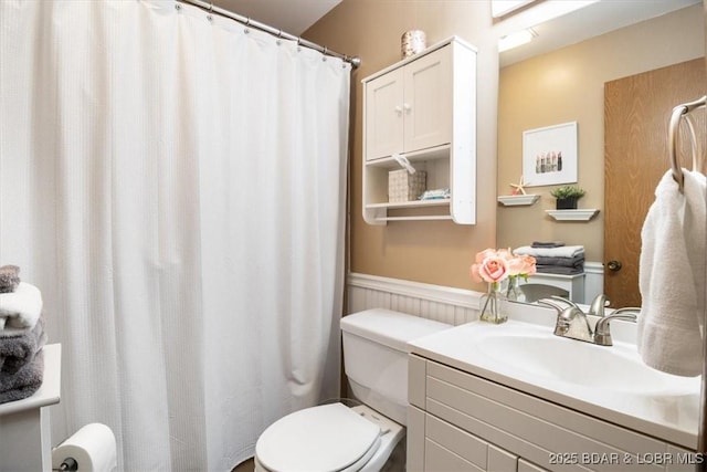 bathroom featuring toilet and vanity