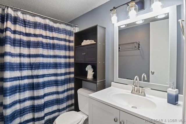 bathroom featuring toilet, a textured ceiling, curtained shower, and vanity