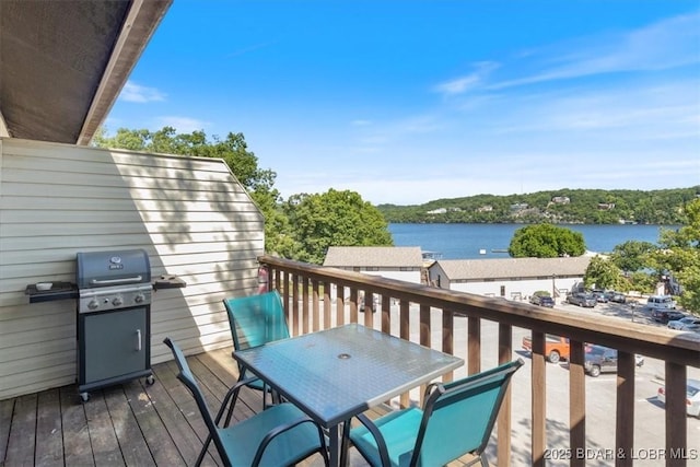 wooden deck with a grill and a water view