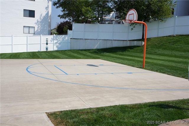 view of basketball court featuring a lawn