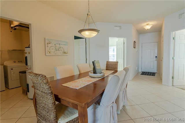 tiled dining room with washing machine and dryer