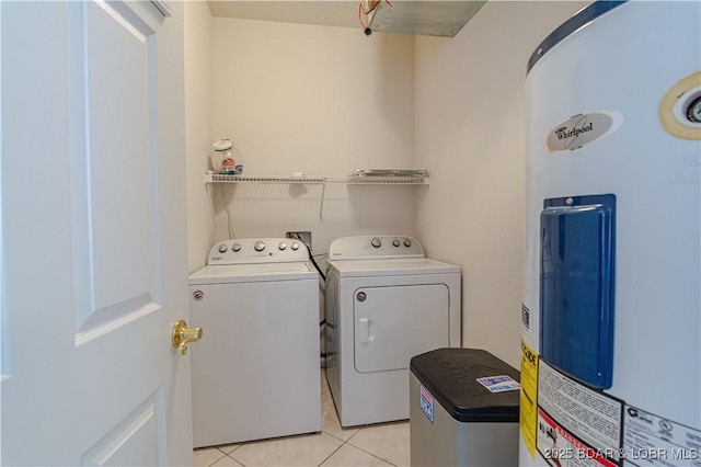 washroom featuring light tile patterned floors, independent washer and dryer, and electric water heater