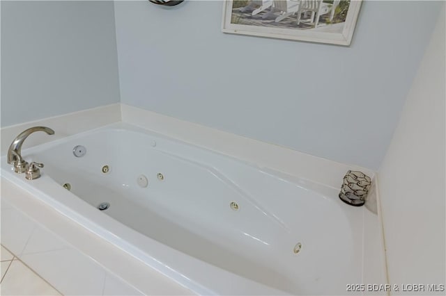 bathroom with a bath and tile patterned floors