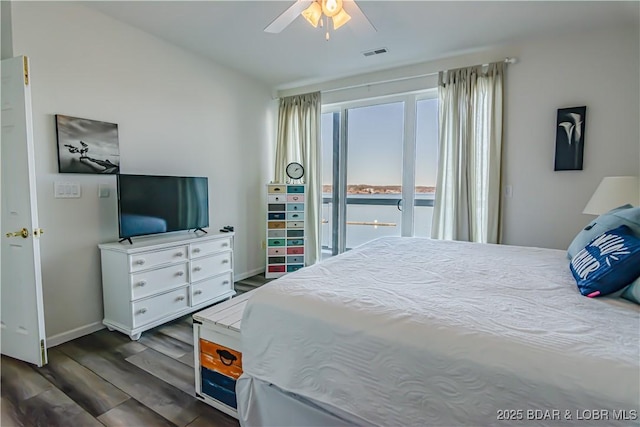 bedroom with ceiling fan, dark hardwood / wood-style flooring, and access to outside