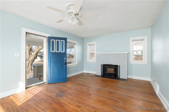 unfurnished living room featuring ceiling fan and dark wood-type flooring