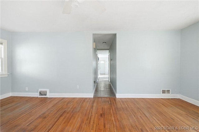 spare room featuring ceiling fan and hardwood / wood-style floors