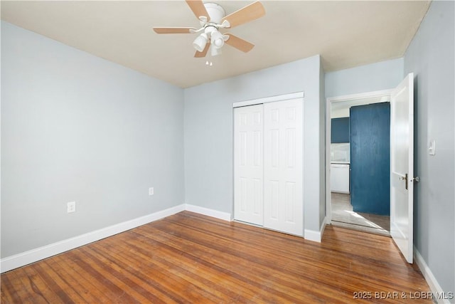 unfurnished bedroom with ceiling fan, a closet, and wood-type flooring