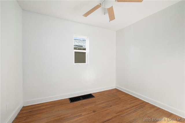 empty room with ceiling fan and hardwood / wood-style floors