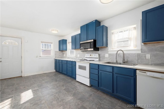 kitchen featuring sink, white appliances, blue cabinetry, and tasteful backsplash