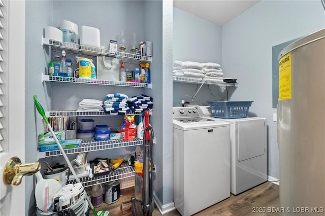 laundry room with water heater, washer and clothes dryer, and hardwood / wood-style floors