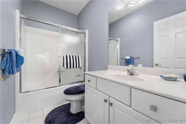 full bathroom with toilet, tile patterned flooring, vanity, and combined bath / shower with glass door