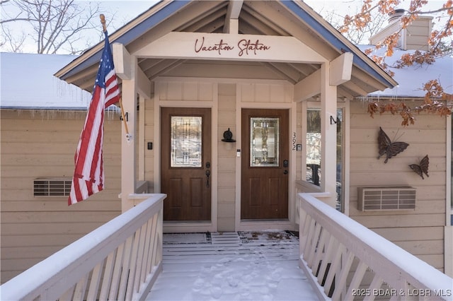 view of snow covered property entrance