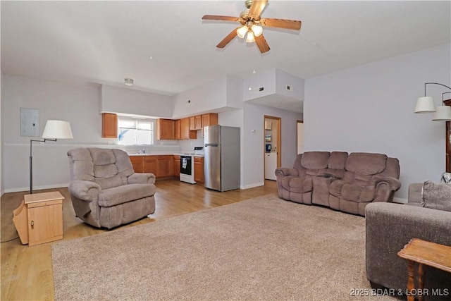 living room with electric panel and ceiling fan