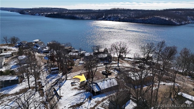 snowy aerial view with a water view