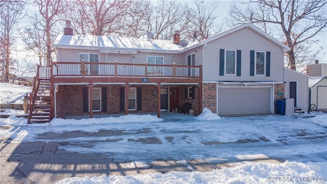 view of front of house with a deck and a garage