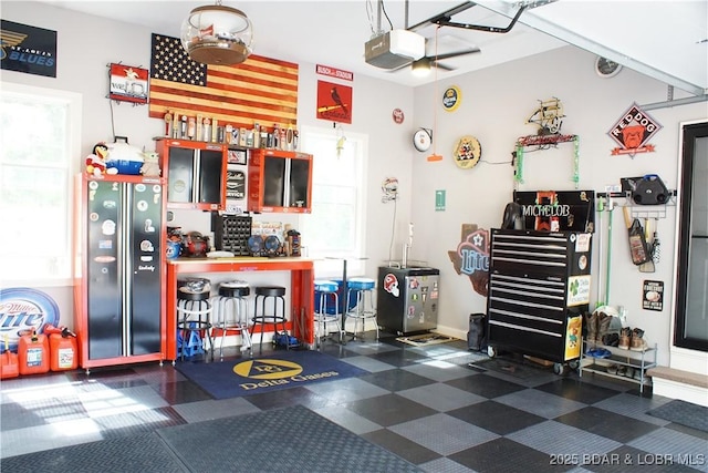 garage with a garage door opener and baseboards