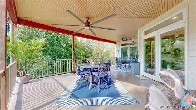 sunroom / solarium with wood ceiling and ceiling fan