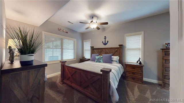 bedroom with a ceiling fan, visible vents, dark carpet, and baseboards