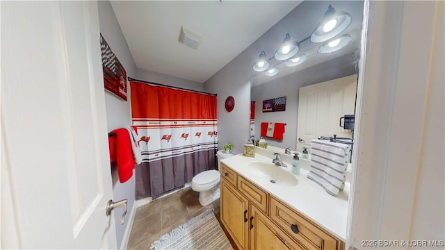 bathroom with toilet, tile patterned flooring, visible vents, and vanity