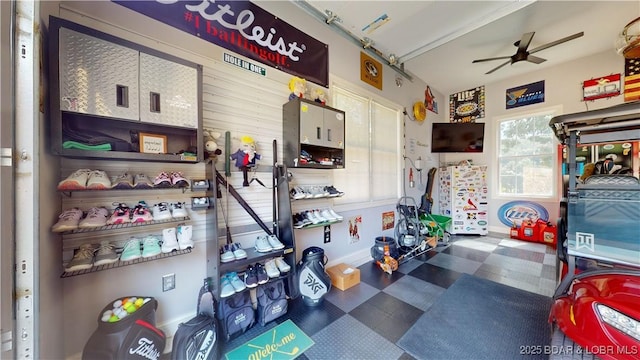 garage with ceiling fan and baseboards