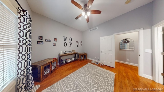 interior space with ceiling fan, lofted ceiling, and light wood-type flooring