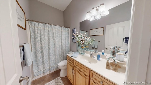 bathroom with toilet, curtained shower, vanity, and tile patterned floors