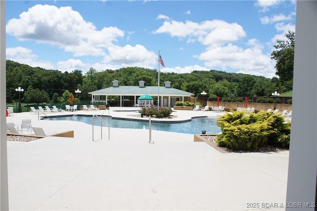 pool featuring a patio and fence