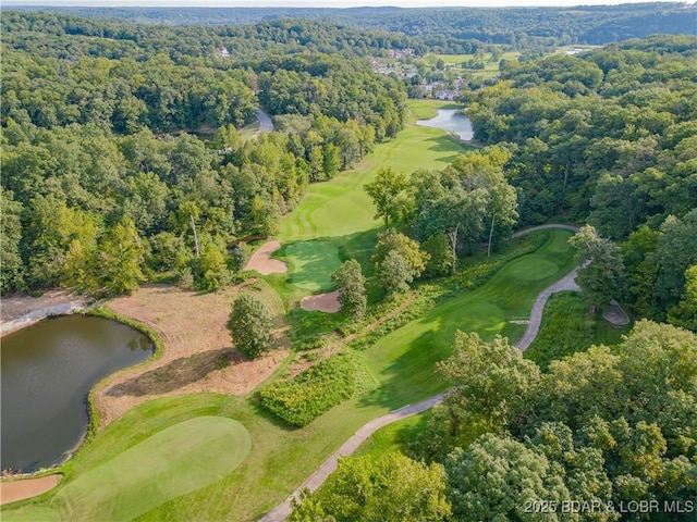 aerial view with view of golf course, a water view, and a view of trees