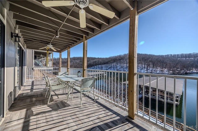 balcony with ceiling fan and a water view