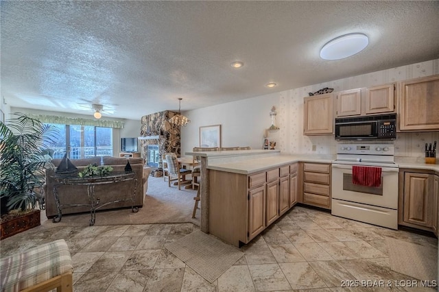 kitchen featuring pendant lighting, a textured ceiling, white electric range, light brown cabinetry, and kitchen peninsula