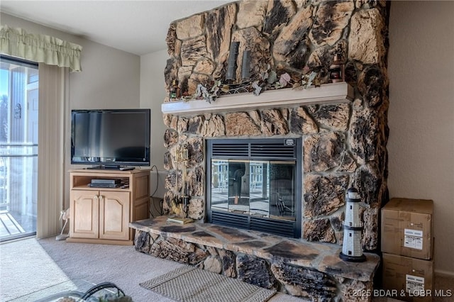 carpeted living room featuring a healthy amount of sunlight and a fireplace