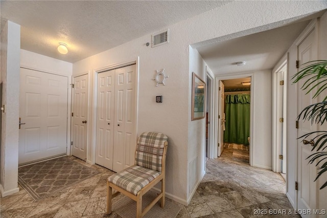 hallway featuring a textured ceiling