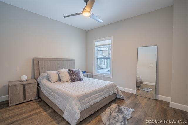 bedroom featuring ceiling fan and dark wood-type flooring