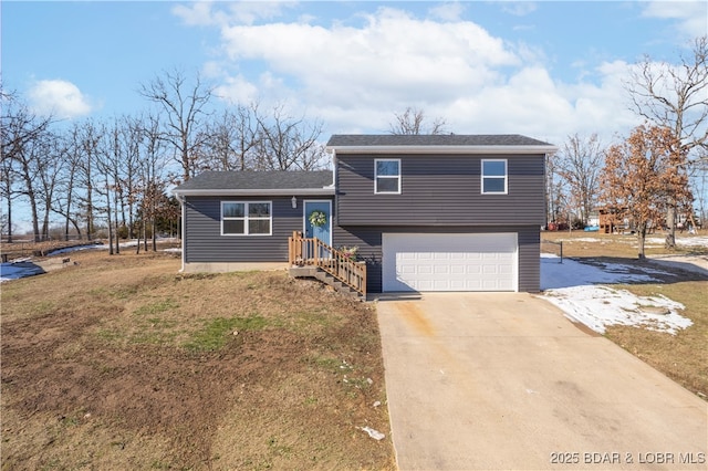 split level home with a front lawn and a garage