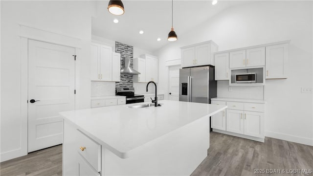 kitchen with decorative light fixtures, stainless steel appliances, white cabinets, and sink