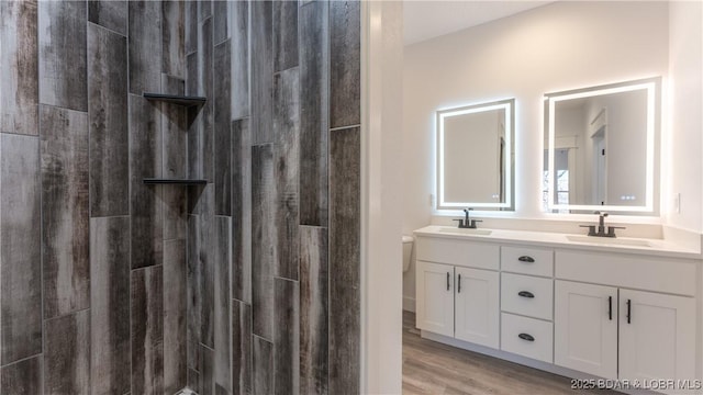 bathroom with a shower, wood-type flooring, toilet, and vanity