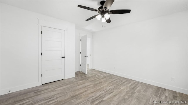 unfurnished bedroom with ceiling fan, a closet, and light hardwood / wood-style floors