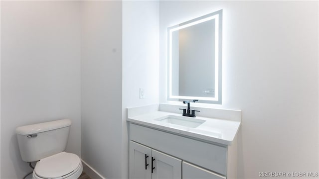 bathroom featuring toilet and vanity