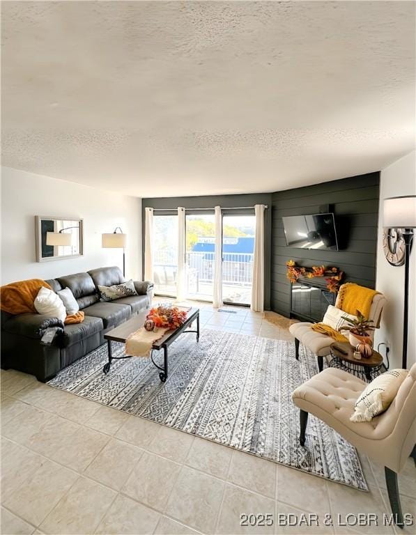 living room featuring light tile patterned floors and a textured ceiling