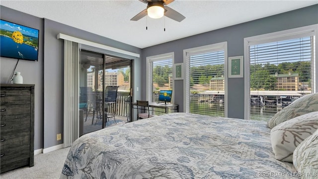 bedroom featuring ceiling fan, light colored carpet, a textured ceiling, and access to outside